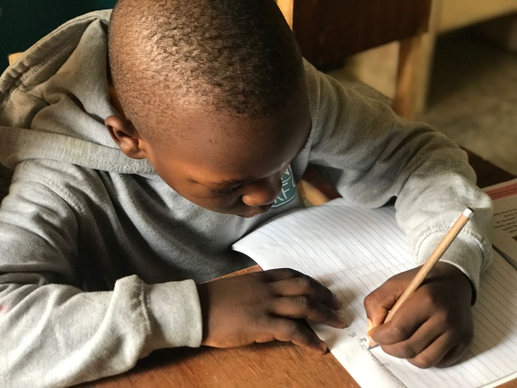 Representative image of a boy writing in class